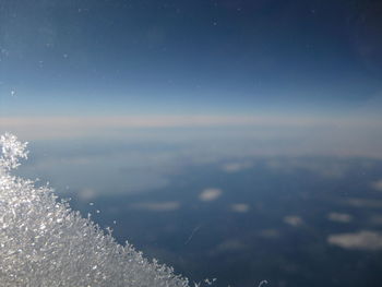 Close-up of ice crystal on airplane window