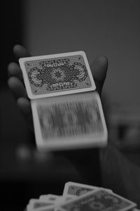 Blurred motion of cards falling from hand at home