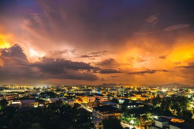 High angle view of illuminated cityscape against sky during sunset