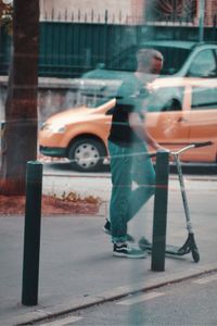 Man standing on street in city