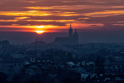 High angle view of townscape against orange sky