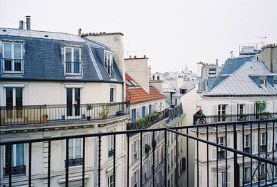 Houses in residential district against sky