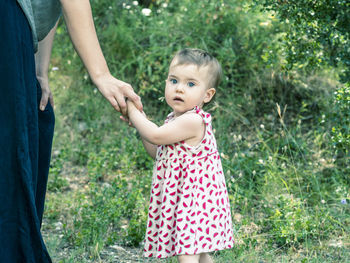 Mother and daughter standing on tree