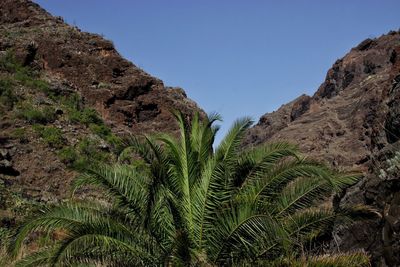 Low angle view of mountain against clear blue sky