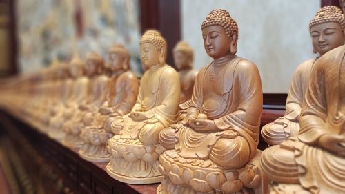 Buddha statue outside temple against building