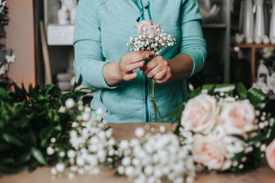 Midsection of woman holding flower bouquet