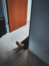 Low section of man sitting on tiled floor