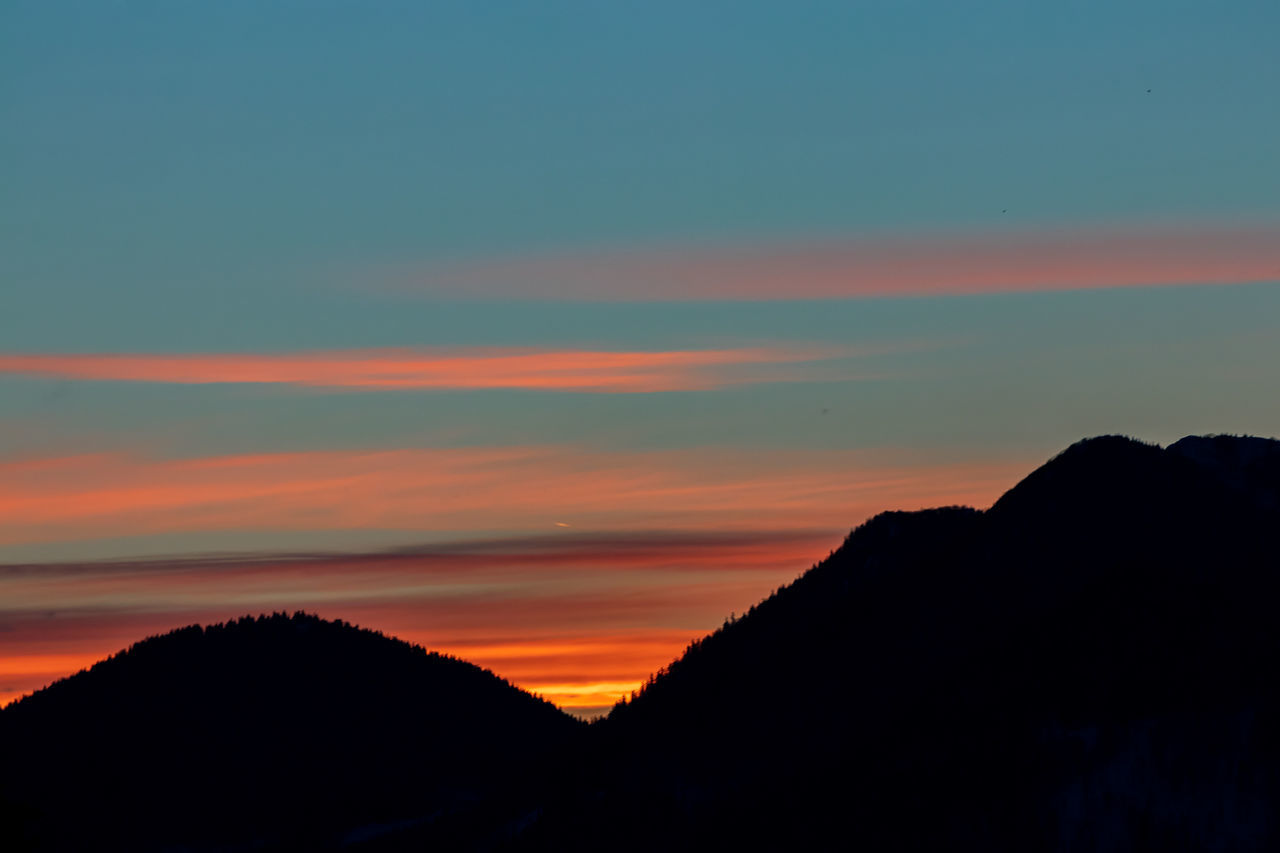 SCENIC VIEW OF SILHOUETTE MOUNTAINS AGAINST ROMANTIC SKY