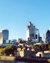 Buildings in city against blue sky