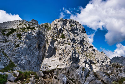 Low angle view of rocky mountains against sky