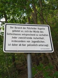 Close-up of information sign board on tree in forest