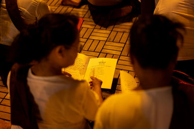 High angle view of people on book