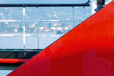 Abstract geometry background with detail of red ship hull at blue sea background. 