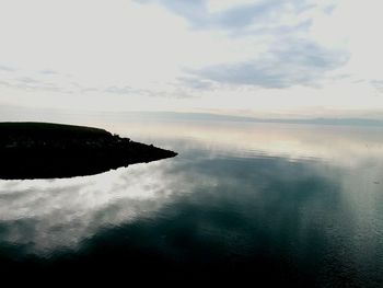 Scenic view of sea against cloudy sky