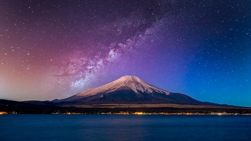 Fuji mountain at yamanachi in japan,  at night with milky way galaxy and kawaguchiko lake, japan.