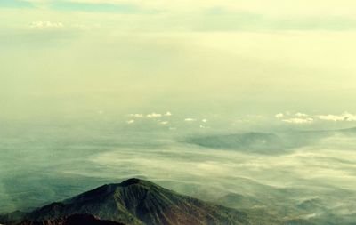 Aerial view of volcanic mountain against sky