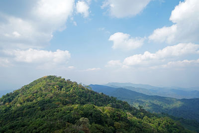 Natural landscape of green mountain range with cloudy blue sky