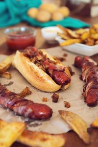 Close-up of bun and sausages on table