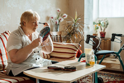 Woman sitting on table at home