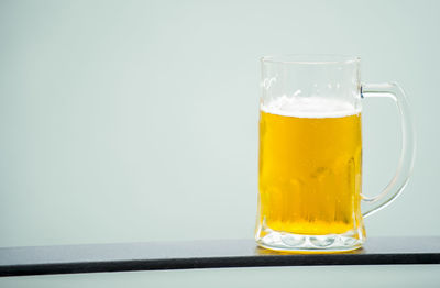 Close-up of beer glass on table