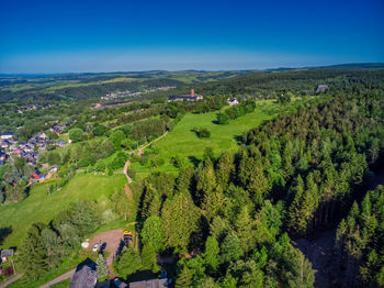 High angle view of trees on field against blue sky