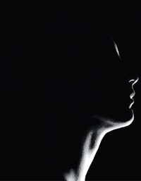 Close-up of hand over black background