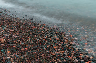 High angle view of pebbles at beach