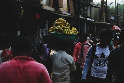 Rear view of people at market