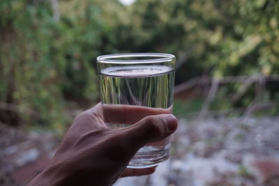 Midsection of person holding drink