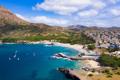 Scenic view of sea and mountains against sky