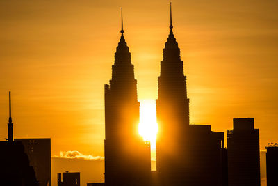 Silhouette of building against sky during sunset