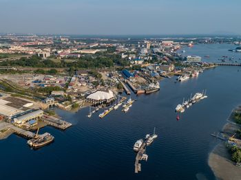 High angle view of cityscape by sea against sky