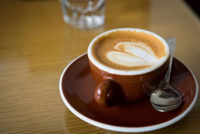 Close-up of cappuccino served on table