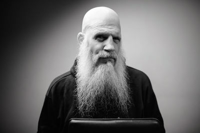 Portrait of man wearing hat against gray background