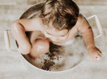 High angle view of baby boy in bathtub