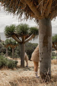 Rear view of couple standing on field