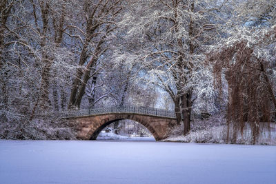 Snow covered arch bridge against sky during winter