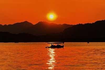 Scenic view of sea against orange sky