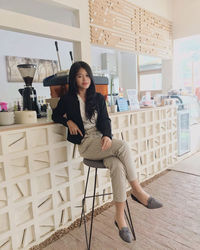 Portrait of woman sitting on chair