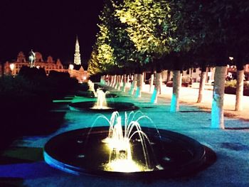 Fountain in illuminated temple at night