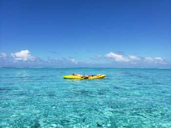 Full length of teenage boy lying on boat in sea