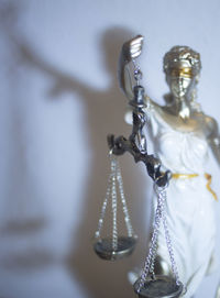 Close-up of lady justice against wall