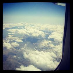 Aerial view of landscape against cloudy sky