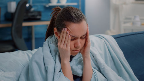 Young woman having headache at clinic