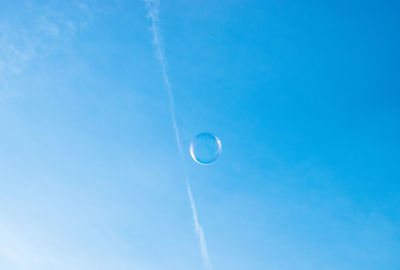 Low angle view of moon against blue sky