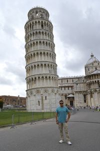 Portrait of man standing against leaning tower of pisa