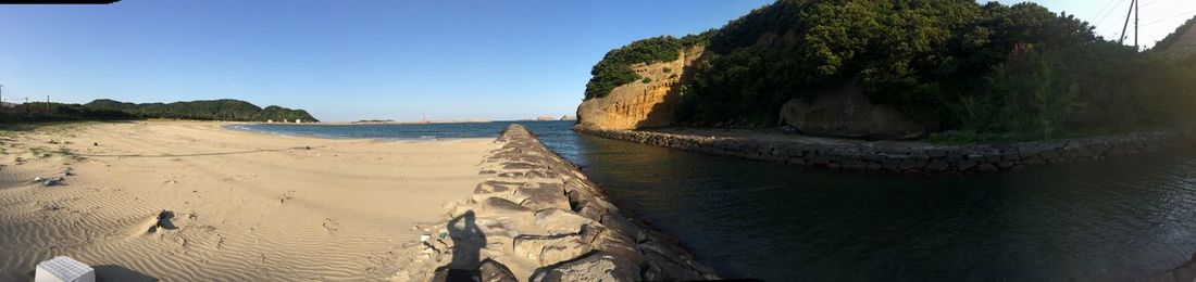 Panoramic shot of sea against clear sky