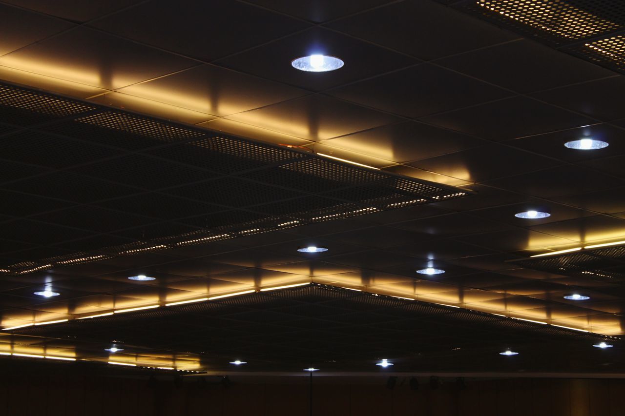 LOW ANGLE VIEW OF ILLUMINATED LIGHTS HANGING AT CEILING