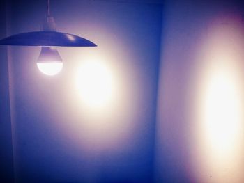 Low angle view of illuminated electric lamp