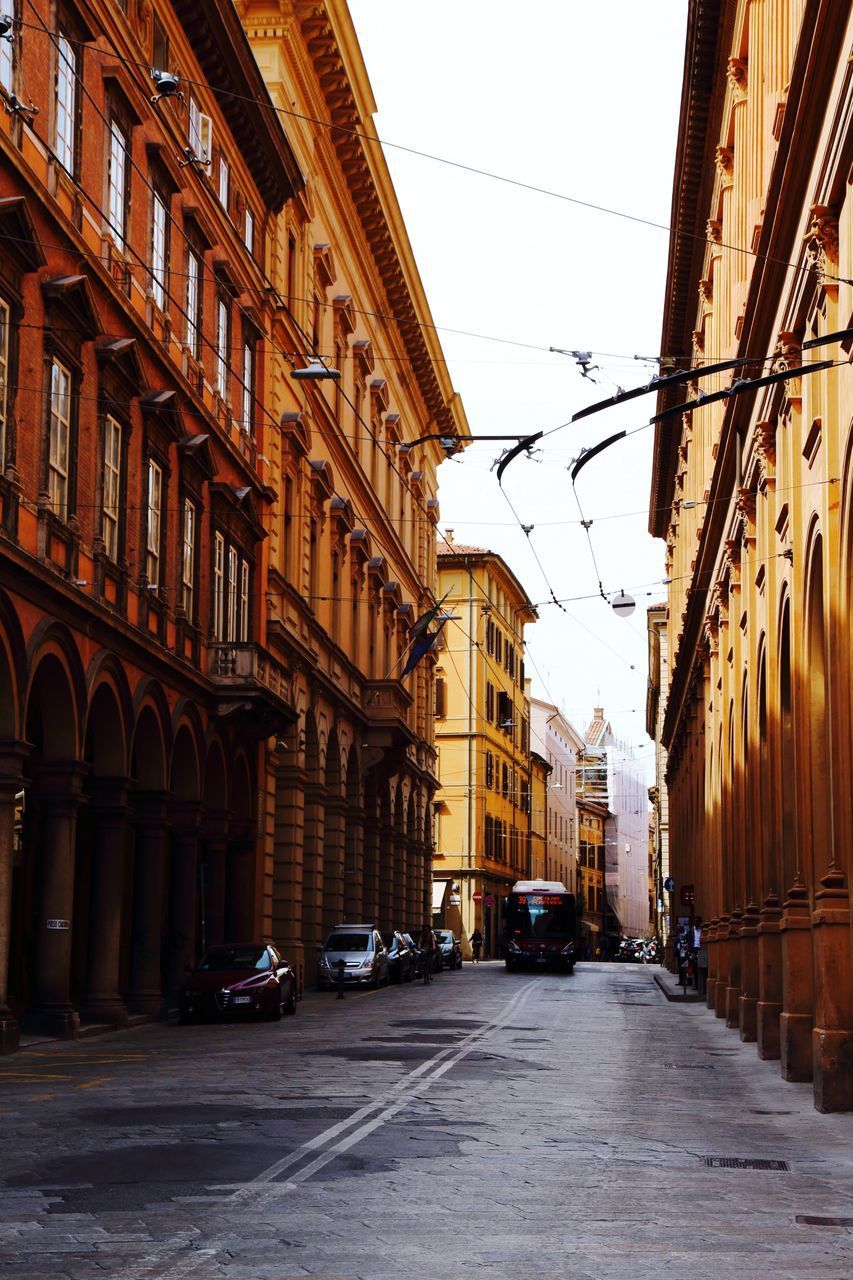 CARS ON STREET AMIDST BUILDINGS IN CITY